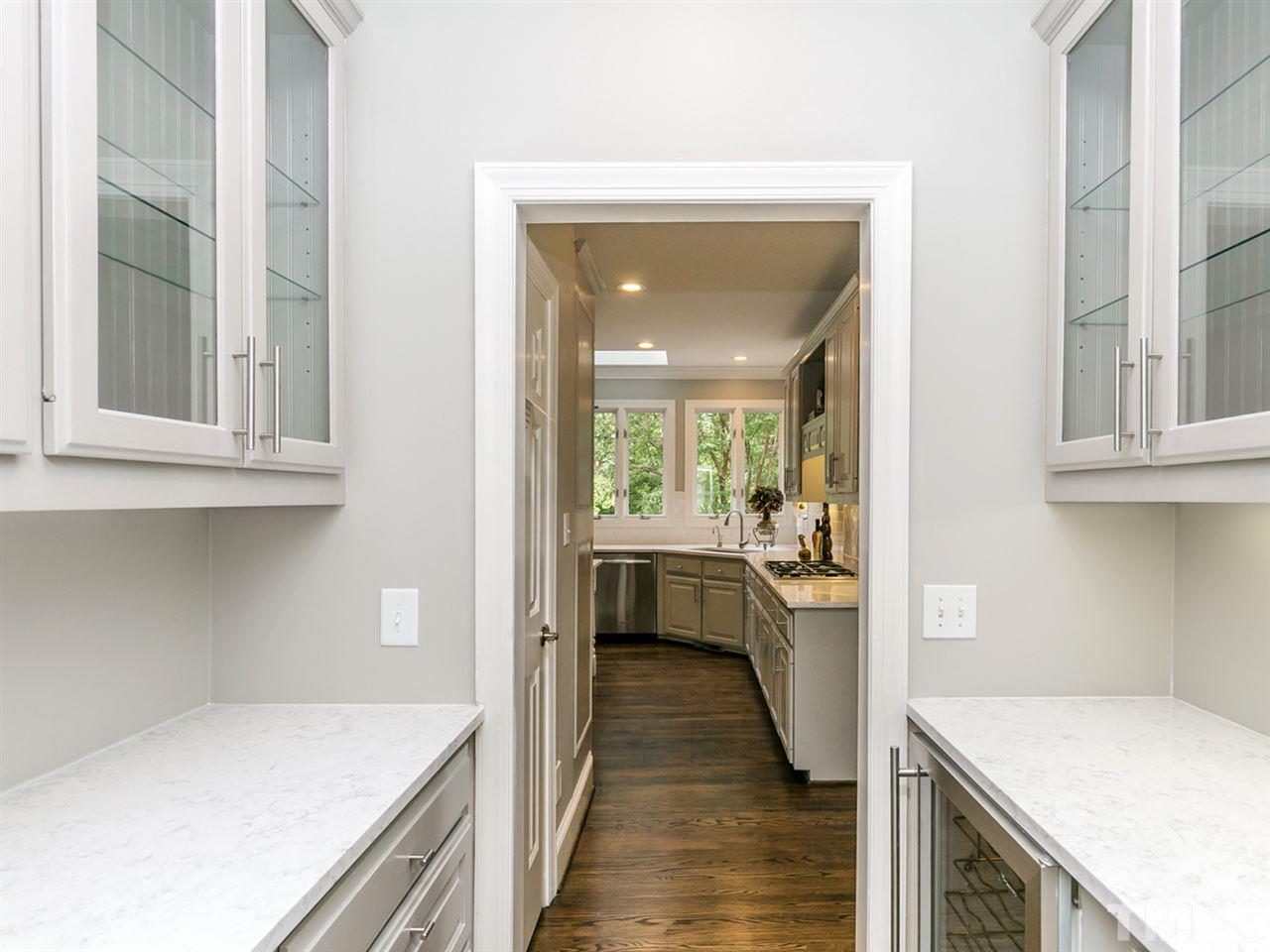 4038 John S Raboteau Wynd Raleigh, NC 27612 - Photo 9 of 25 a kitchen with a stove a sink and a refrigerator