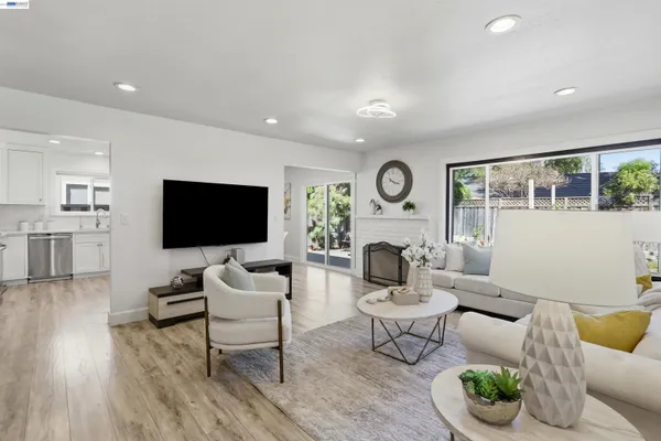 a living room with fireplace furniture and a flat screen tv