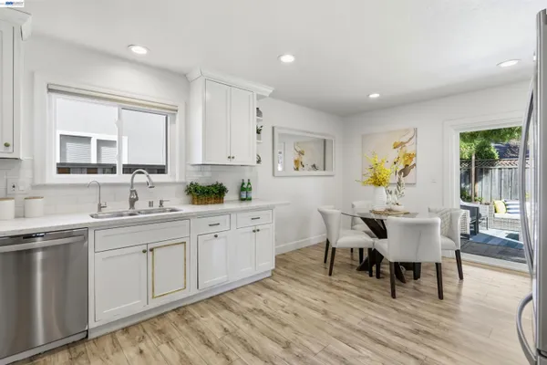 a kitchen with cabinets table and chairs
