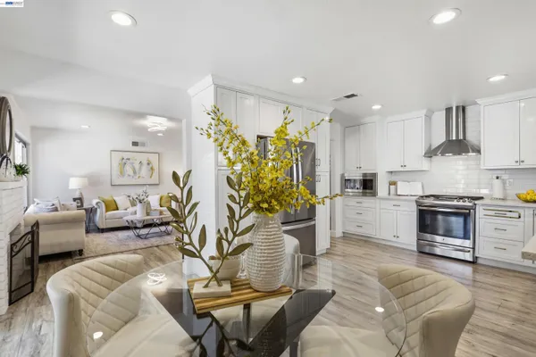 a living room with furniture appliances and a kitchen