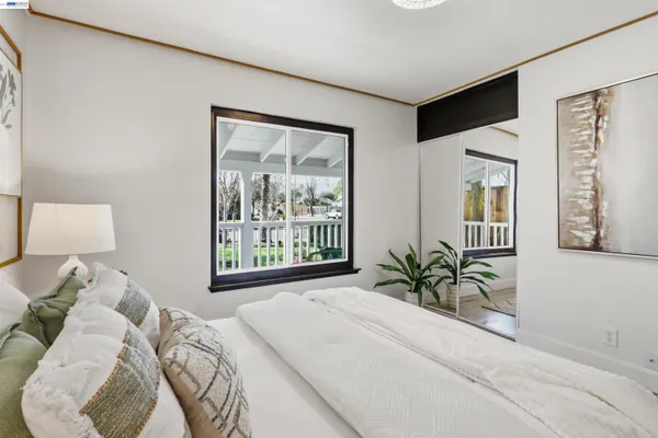 a spacious bedroom with a bed and a couch
