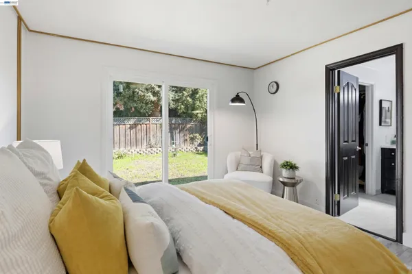 a bedroom with a bed and a painting on the wall