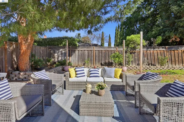 a view of a house with backyard sitting area and swimming pool