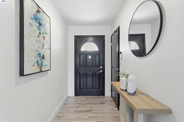 a view of a hallway with wooden floor and entryway