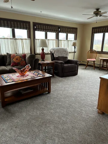 a living room with furniture and large windows