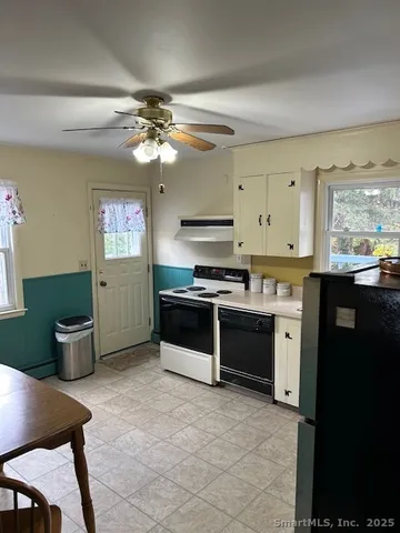 a kitchen with stainless steel appliances a stove a sink and a refrigerator