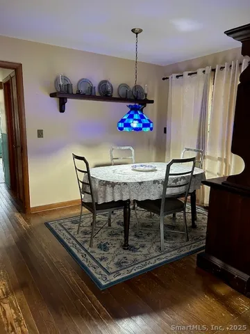a view of a dining room with furniture and chandelier