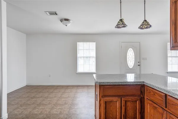 a view of room with window and wooden floor