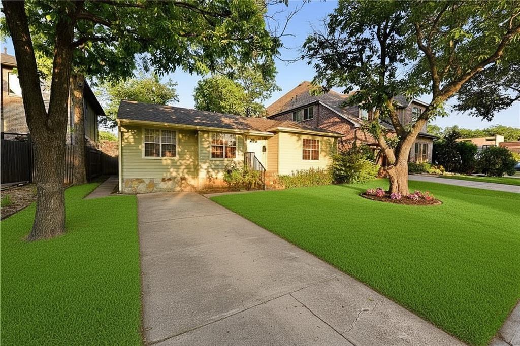 a front view of house with yard and green space