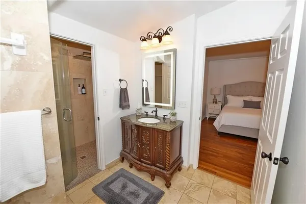 a view of a hallway with a living room and mirror