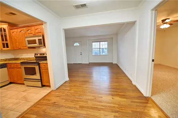 a view of a kitchen with a sink and dishwasher wooden floor