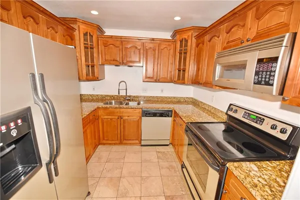 a kitchen with stainless steel appliances a stove a sink and a refrigerator
