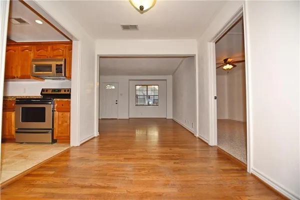 a view of a livingroom with a kitchen and a window