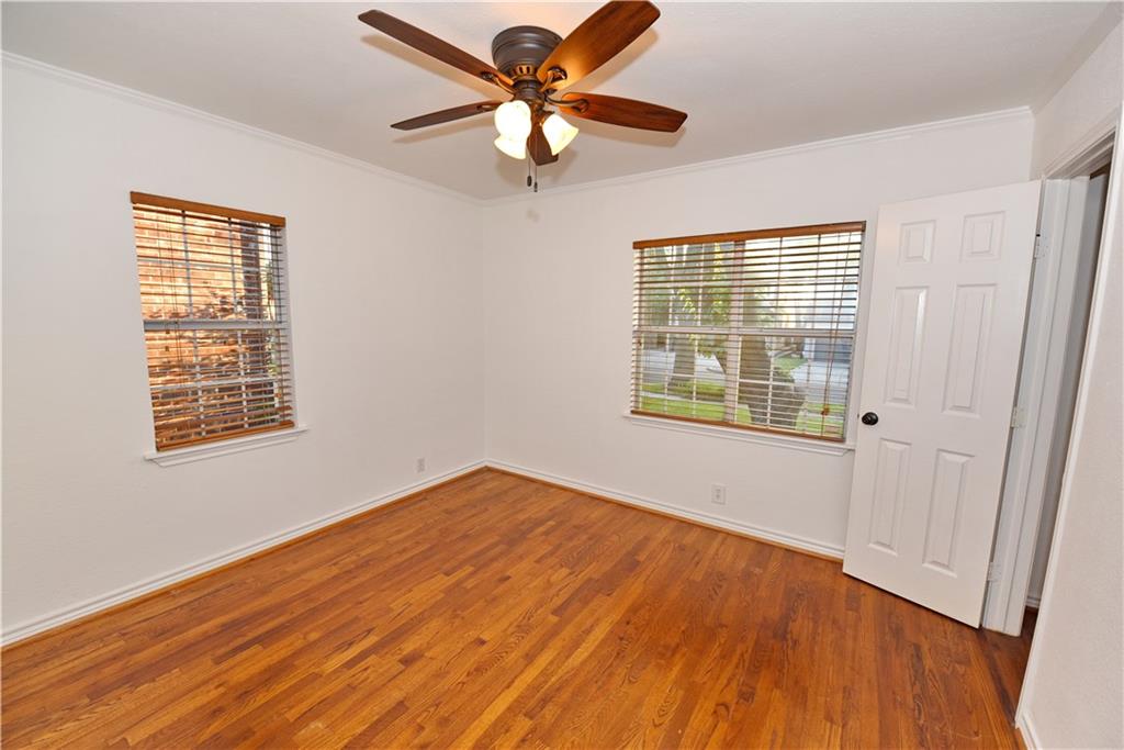 8502 Ridgelea Street Dallas, TX 75209 - Photo 29 of 37 a view of an empty room with wooden floor and a window