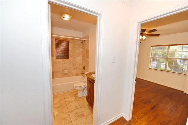 a view of a bathroom with a glass door and a window
