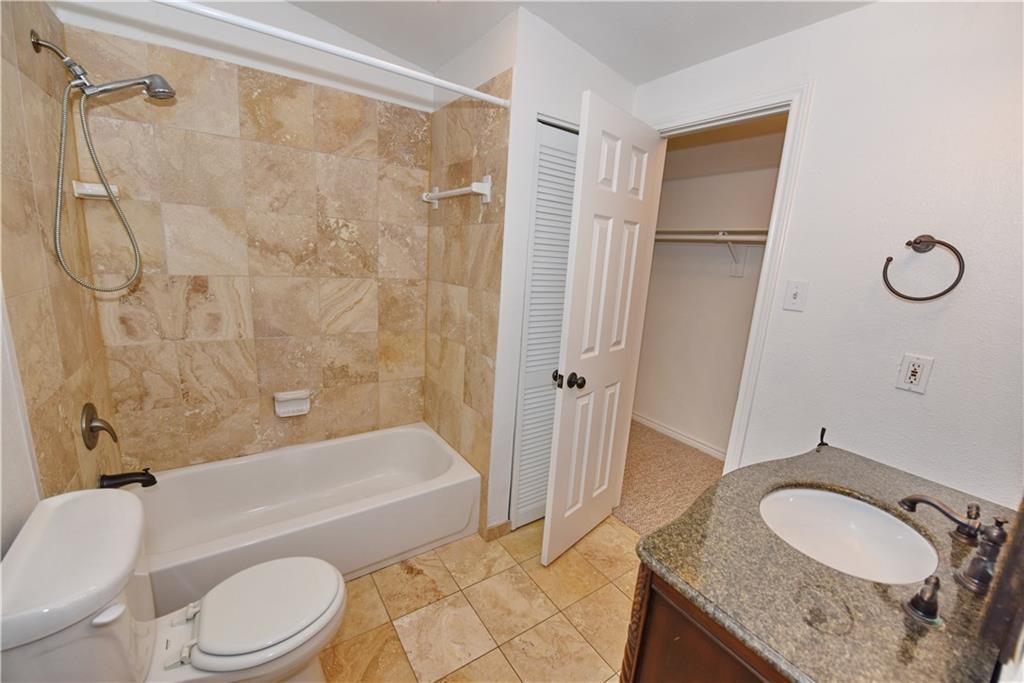8502 Ridgelea Street Dallas, TX 75209 - Photo 35 of 37 a bathroom with a granite countertop sink toilet and shower
