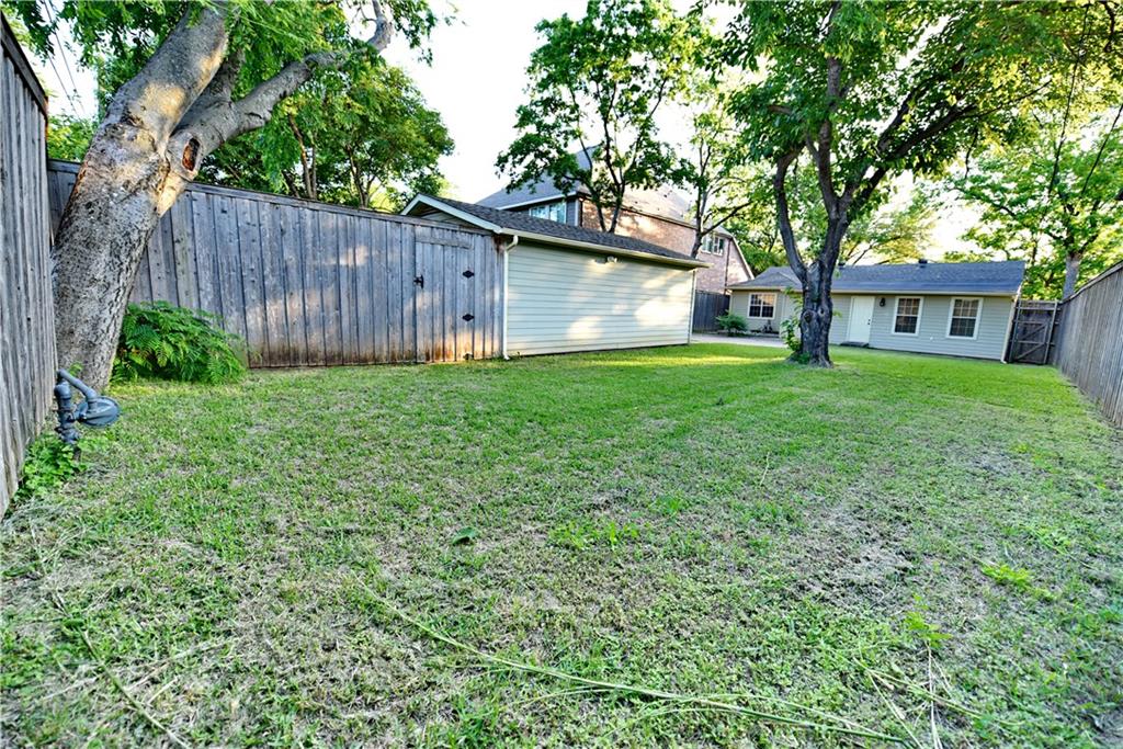 8502 Ridgelea Street Dallas, TX 75209 - Photo 4 of 37 a view of a backyard with table and chairs and a large tree