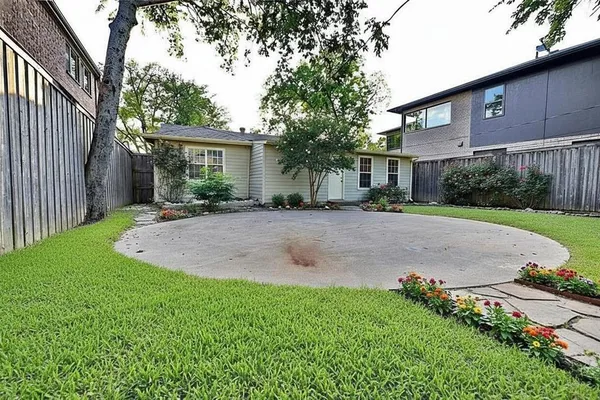 a backyard of a house with plants and trees