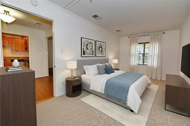 a bedroom with a bed and a couch