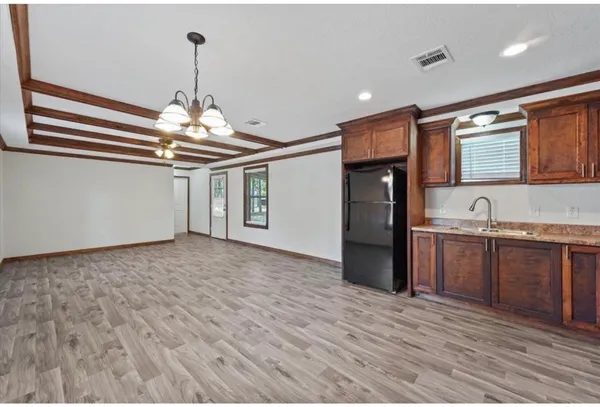 a view of a kitchen with a sink and refrigerator