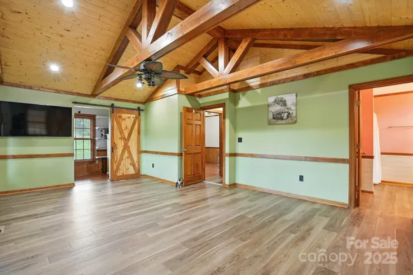 a view of a room with wooden floor