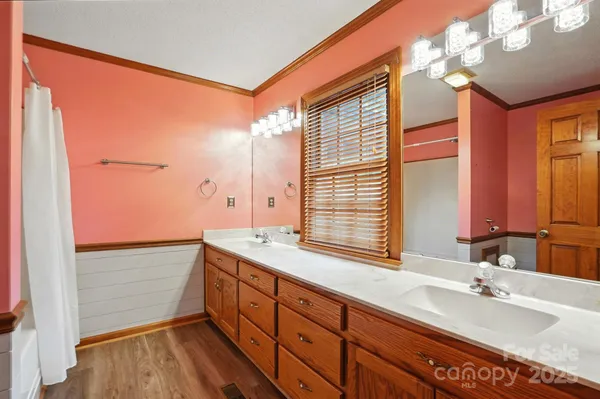 a bathroom with a double vanity sink and a mirror
