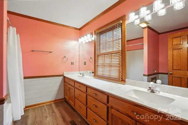a bathroom with a double vanity sink and a mirror