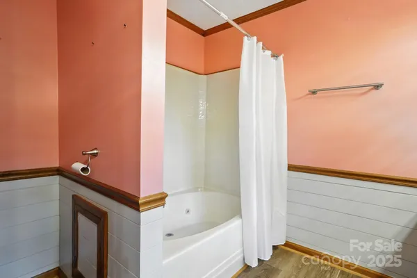 a bathroom with a bathtub and shower