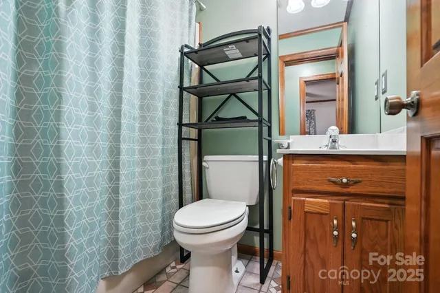 a bathroom with a toilet a sink and mirror