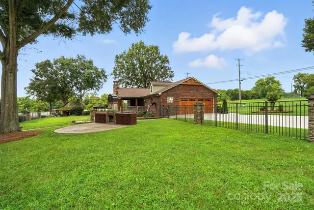 a view of a house with a big yard and garden