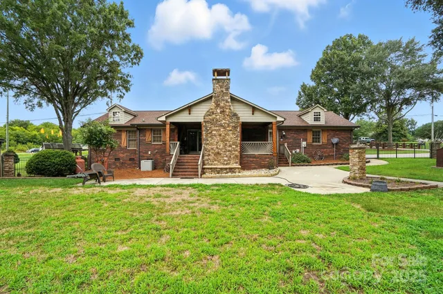 a front view of a house with a yard table and chairs