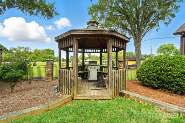 a view of a deck with a table and chairs under an umbrella