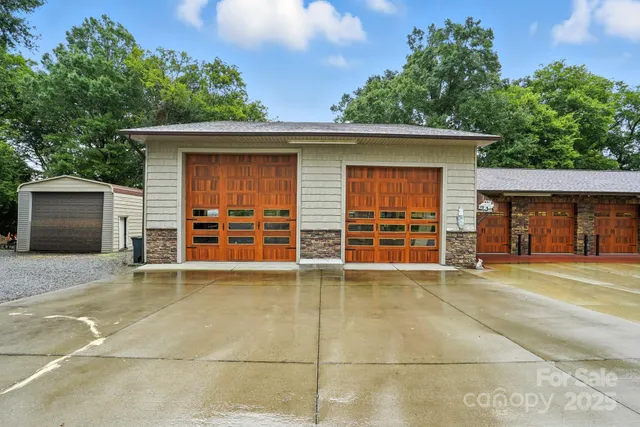 front view of a house with a garage and a chair