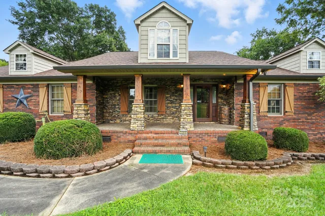 a front view of a house with garden and garage