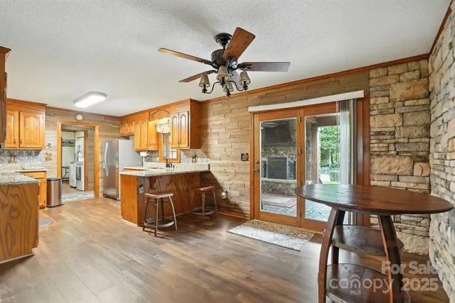 a view of a livingroom with furniture and a kitchen