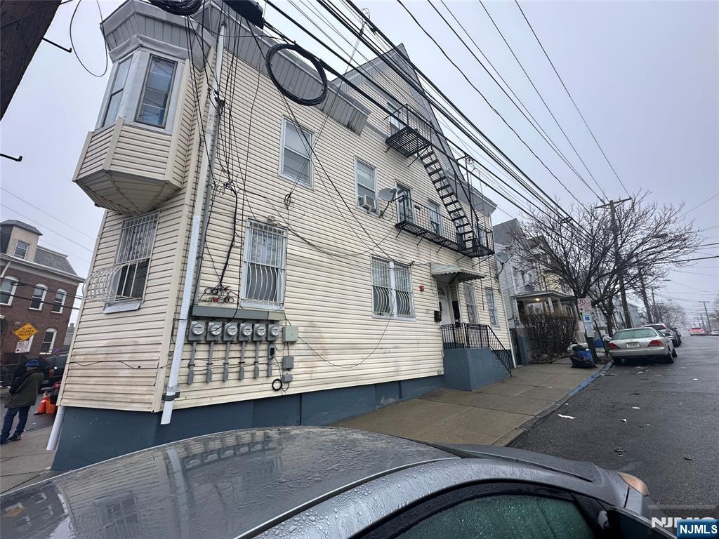 95-99 Lyon Street Paterson, NJ 07524 - Photo 3 of 3 a view of a street with wooden fence