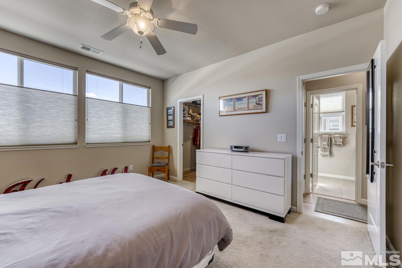 2490 Eastshore Place, Unit 208 Reno, NV 89509 - Photo 21 of 36 a bedroom with a bed and a chandelier