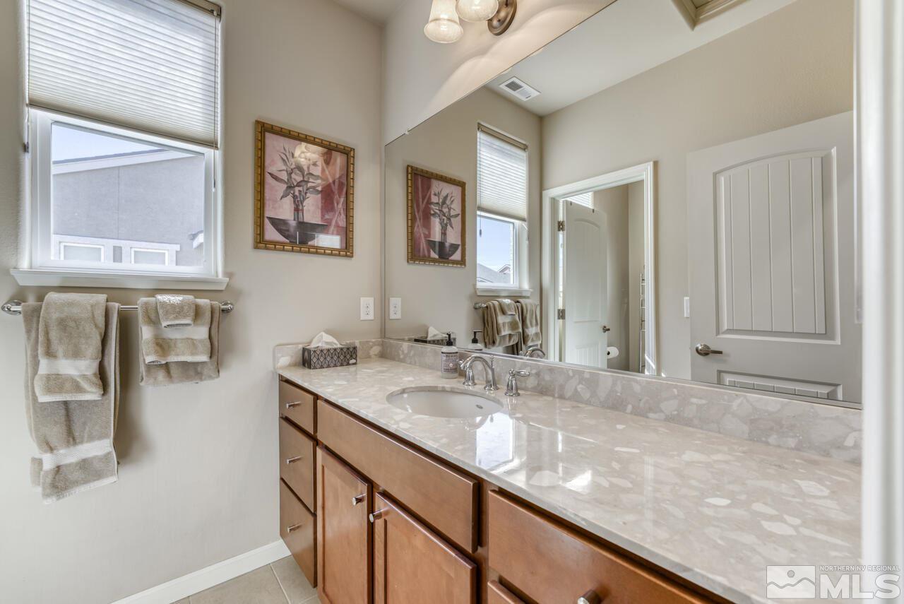2490 Eastshore Place, Unit 208 Reno, NV 89509 - Photo 23 of 36 a bathroom with a sink and a mirror