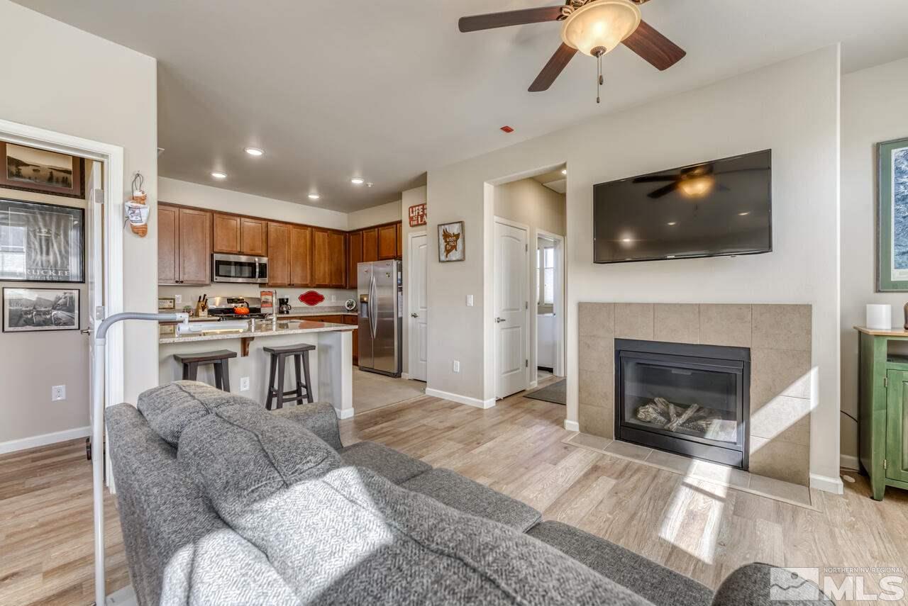 2490 Eastshore Place, Unit 208 Reno, NV 89509 - Photo 5 of 36 a living room with furniture and a fireplace