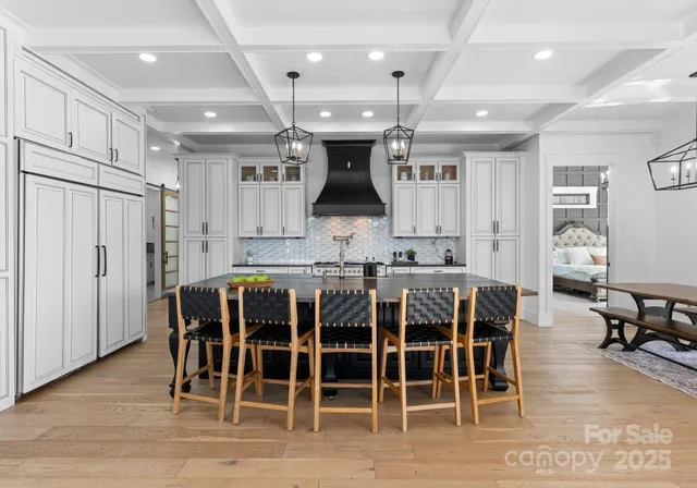 a large kitchen with a table and chairs