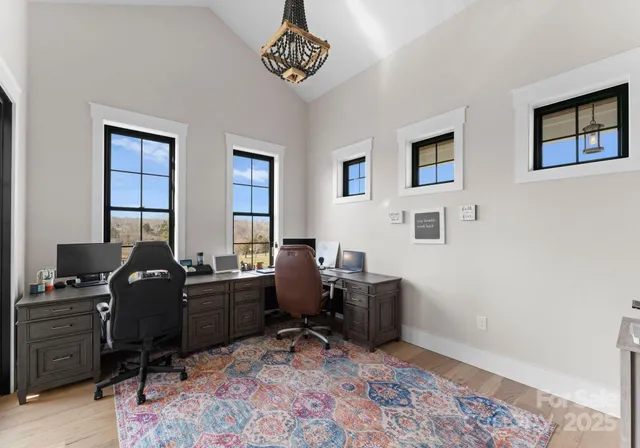 a view of a workspace with furniture and a window
