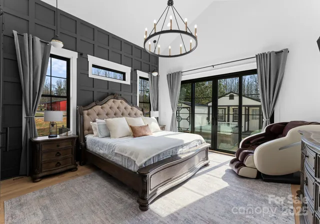 a living room with a bed furniture and a large window