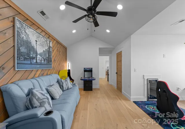 a living room with furniture and wooden floor