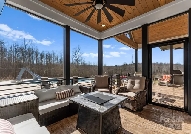 a living room with furniture and a floor to ceiling window