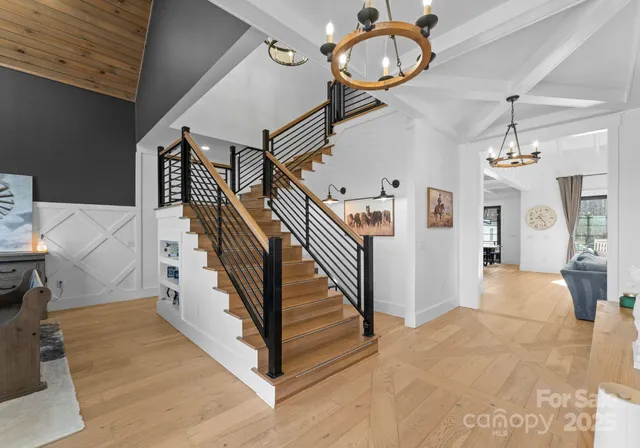 a view of entryway and hall with wooden floor