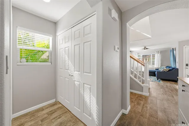 a view of a hallway with wooden floor and windows
