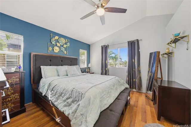 a bedroom with bed and a flat tv screen on dresser