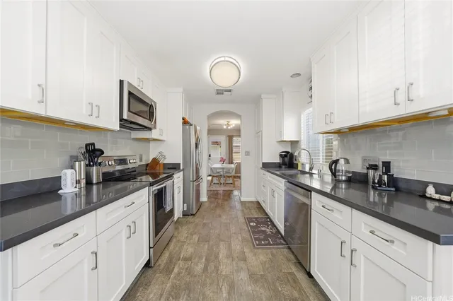 a large kitchen with stainless steel appliances granite countertop a lot of counter space and cabinets