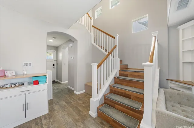 a view of storage and utility room with wooden floor and stairs