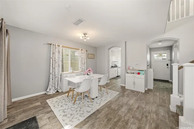 a living room with furniture a table and white walls